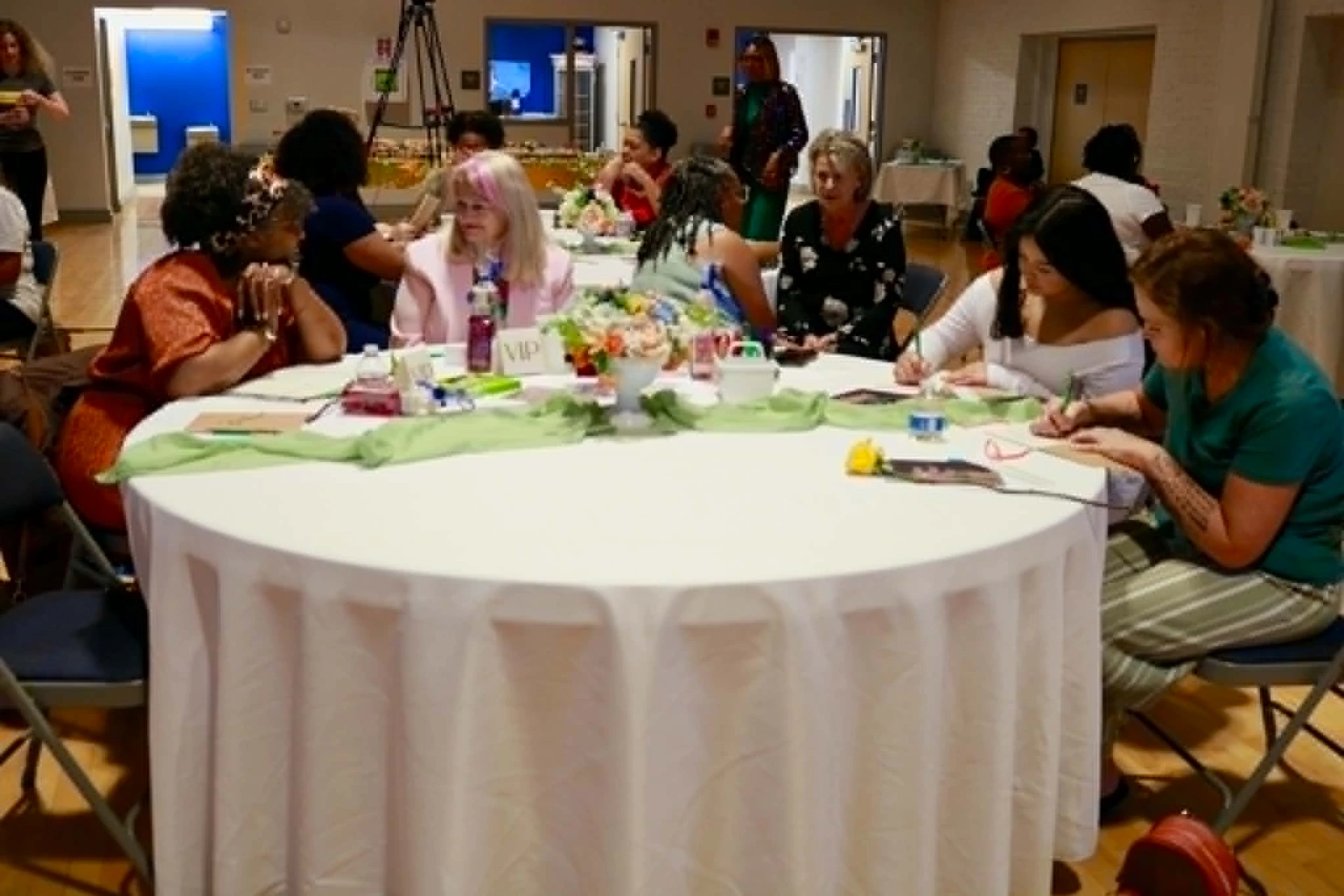 Women journaling together at a workshop table