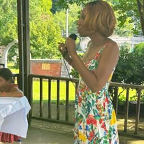 Camisha speaking at an outdoor pavilion event