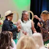 Camisha celebrating with attendees at an event