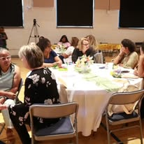 Women gathered around a table at a wellness luncheon