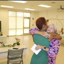 Camisha embracing an attendee after a gathering