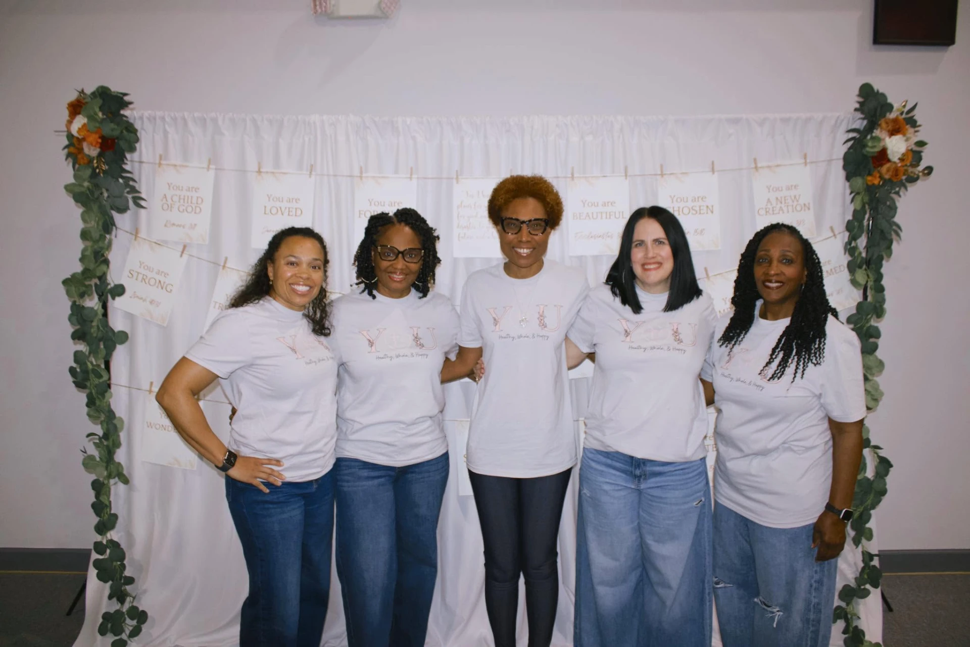 Camisha with her team in matching 'You: Healthy, Whole, & Happy' shirts